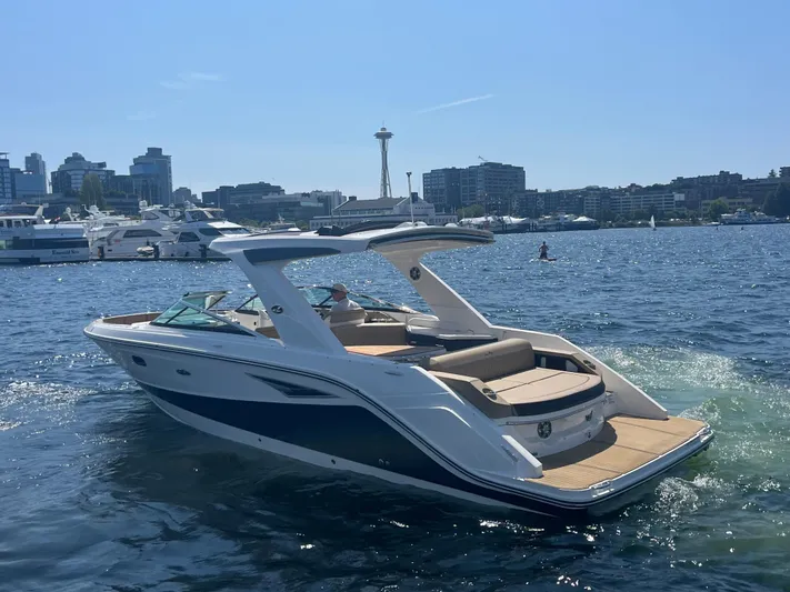  Yacht Photos Pics 2021 Sea Ray SLX 310 boat on water with city skyline in background.