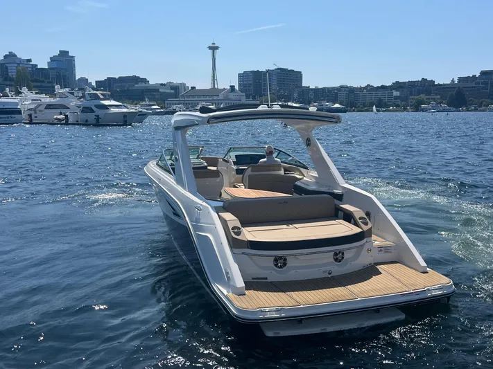  Yacht Photos Pics 2021 Sea Ray SLX 310 boat on water with city skyline in background.