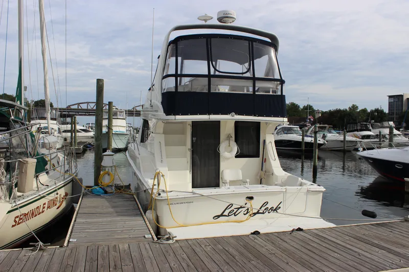  Yacht Photos Pics 2007 Silverton 36 Convertible yacht docked at marina, surrounded by other boats.