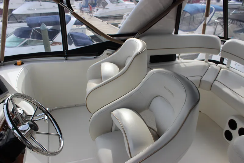 Yacht Photos Pics Interior of 2007 Silverton 36 Convertible yacht with plush white seating and steering wheel.