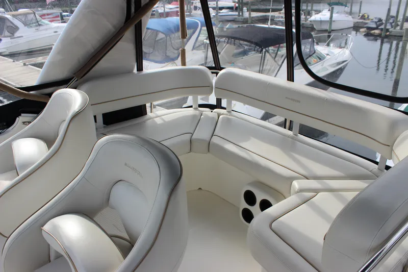  Yacht Photos Pics 2007 Silverton 36 Convertible boat interior with white leather seating and marina view.