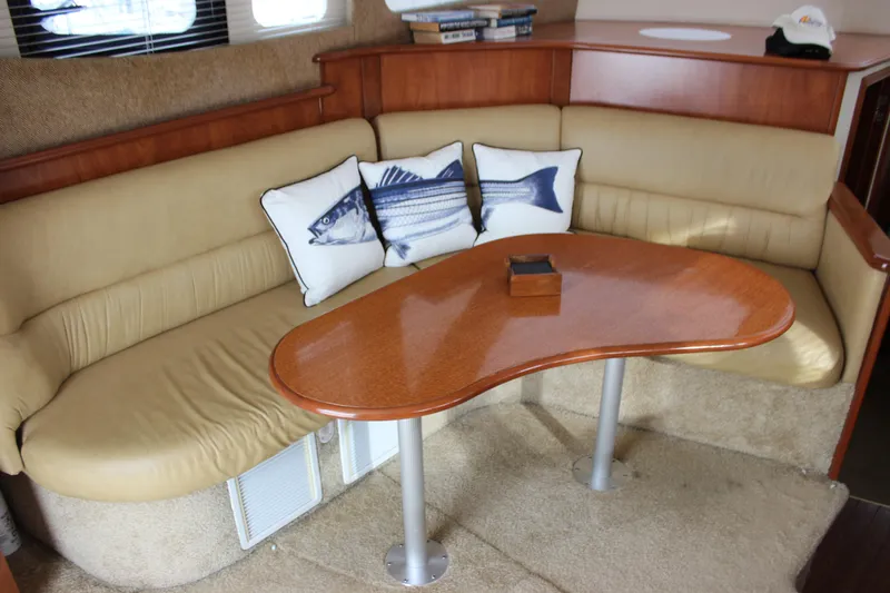  Yacht Photos Pics Interior of 2007 Silverton 36 Convertible with beige seating and fish-themed pillows.
