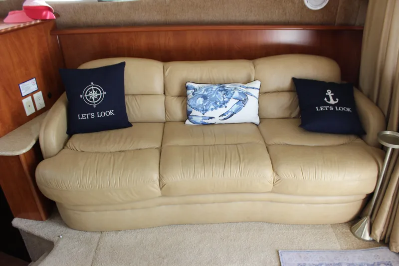  Yacht Photos Pics Beige leather sofa with nautical-themed pillows in a 2007 Silverton 36 Convertible yacht.