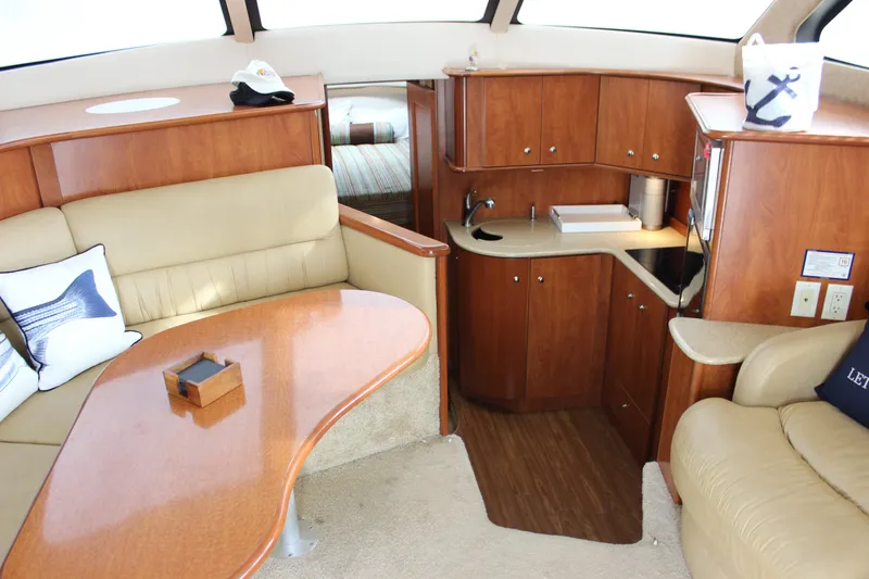  Yacht Photos Pics Interior of 2007 Silverton 36 Convertible yacht with elegant wood cabinetry and cozy seating area.