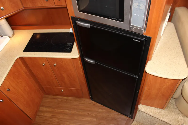  Yacht Photos Pics 2007 Silverton 36 Convertible yacht kitchen with stove, microwave, and fridge.