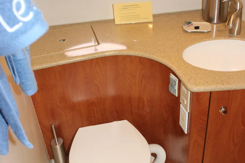  Yacht Photos Pics Bathroom interior of 2007 Silverton 36 Convertible yacht with wooden cabinetry and modern fixtures.