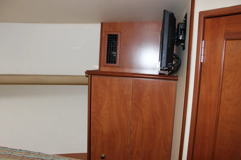  Yacht Photos Pics Interior of 2007 Silverton 36 Convertible yacht with wooden cabinetry and mounted TV.