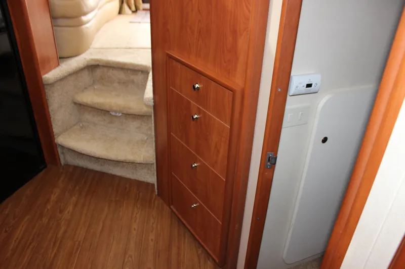  Yacht Photos Pics Interior of 2007 Silverton 36 Convertible with wooden cabinetry and carpeted stairs.