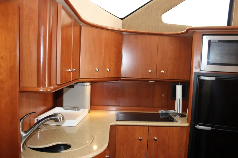 Yacht Photos Pics Luxurious 2007 Silverton 36 Convertible yacht kitchen with wood cabinets and modern appliances.
