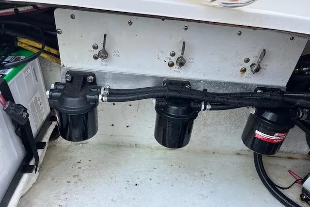 Sashimi Yacht Photos Pics Engine compartment of 2006 Fountain 38 Tournament Edition boat, showing fuel filters and switches.
