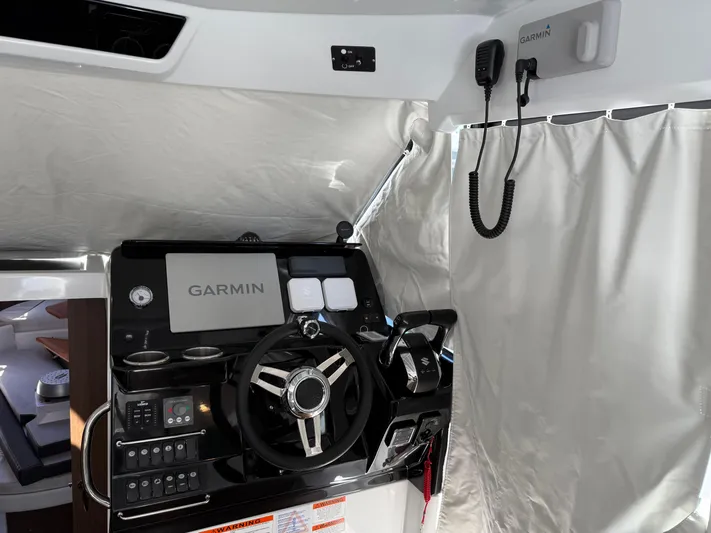  Yacht Photos Pics 2022 Jeanneau NC 1095 Coupe helm with Garmin navigation system and controls.