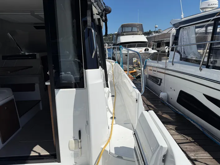  Yacht Photos Pics 2022 Jeanneau NC 1095 Coupe docked, showcasing sleek design and modern features.