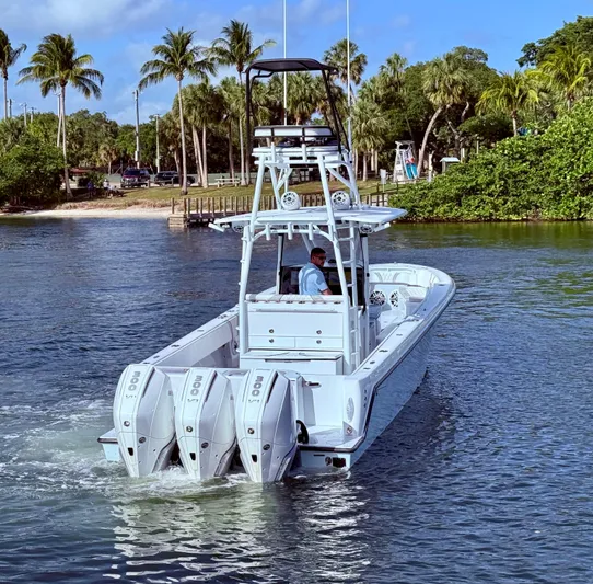  Yacht Photos Pics 2024 Contender 39 ST boat with triple engines cruising in tropical waters.