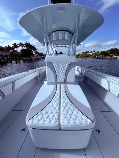  Yacht Photos Pics 2024 Contender 39 ST boat interior with luxurious seating and sleek design on a sunny day.