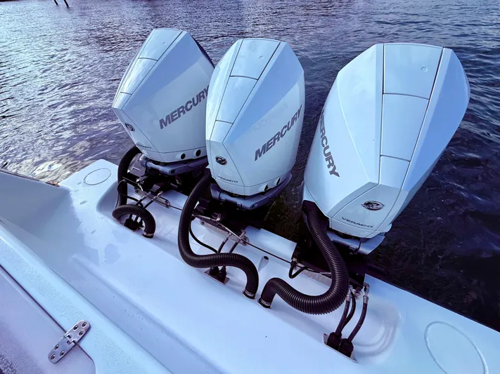  Yacht Photos Pics Triple Mercury outboard engines on 2024 Contender 39 ST boat, docked on water.