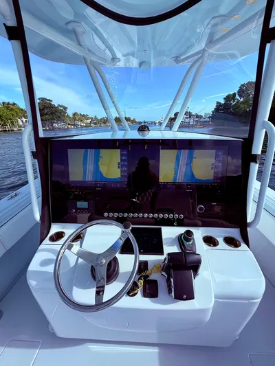  Yacht Photos Pics 2024 Contender 39 ST boat helm with advanced navigation system and steering wheel.