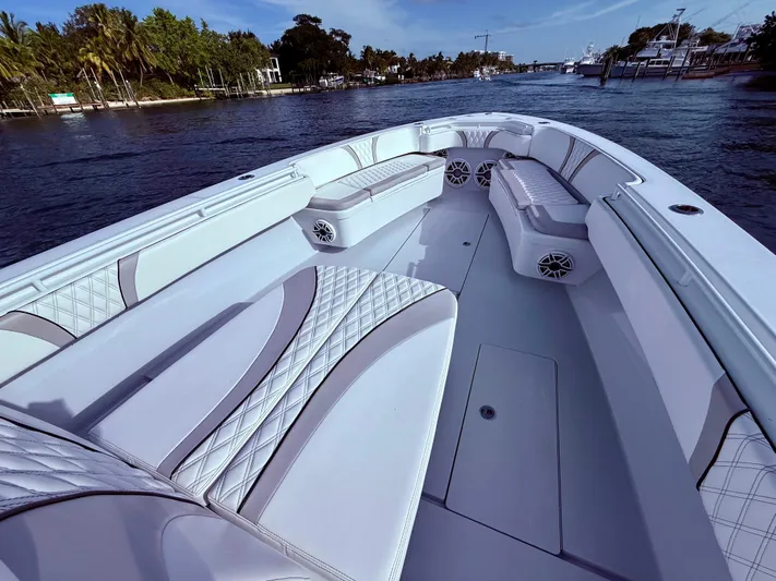  Yacht Photos Pics 2024 Contender 39 ST boat interior with luxurious seating on a calm waterway.