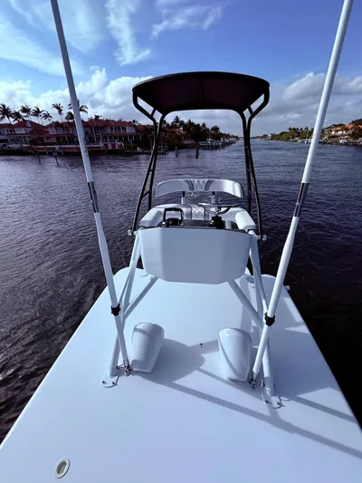 Yacht Photos Pics 2024 Contender 39 ST boat on calm water with scenic background.