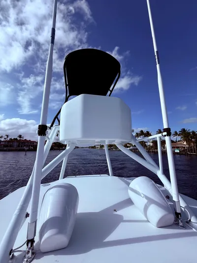  Yacht Photos Pics 2024 Contender 39 ST boat with tower against a blue sky and waterfront view.