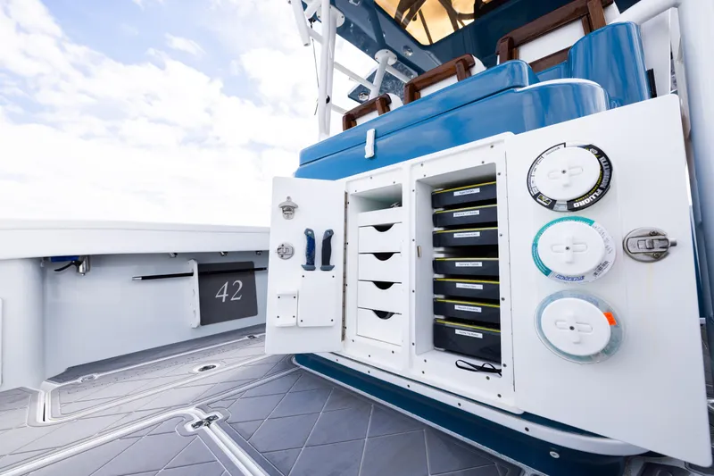 Fishistics Yacht Photos Pics 2024 Yellowfin 42 Offshore boat with open storage compartments and fishing gear.