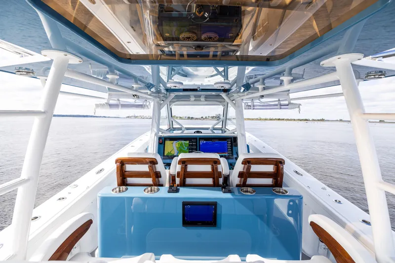 Fishistics Yacht Photos Pics 2024 Yellowfin 42 Offshore boat interior with advanced navigation system and luxurious seating.