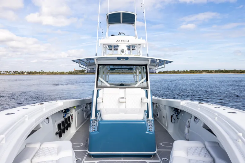 Fishistics Yacht Photos Pics 2024 Yellowfin 42 Offshore boat on calm water, featuring spacious deck and advanced navigation.