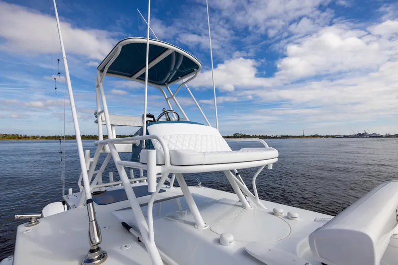 Fishistics Yacht Photos Pics 2024 Yellowfin 42 Offshore boat on calm water under a blue sky.