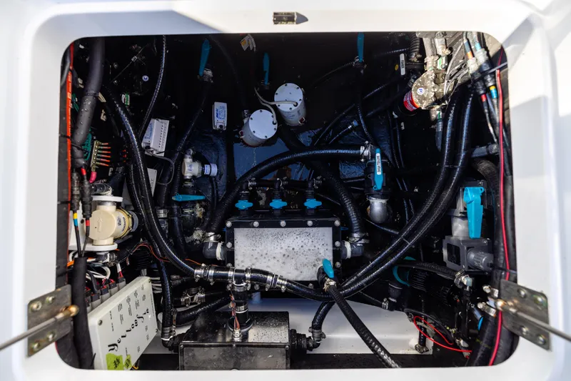 Fishistics Yacht Photos Pics Engine compartment of 2024 Yellowfin 42 Offshore boat, showcasing complex wiring and components.