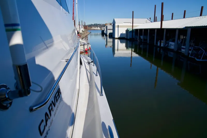  Yacht Photos Pics Carver 506 Motor Yacht, 2000 model, docked in a serene marina setting.