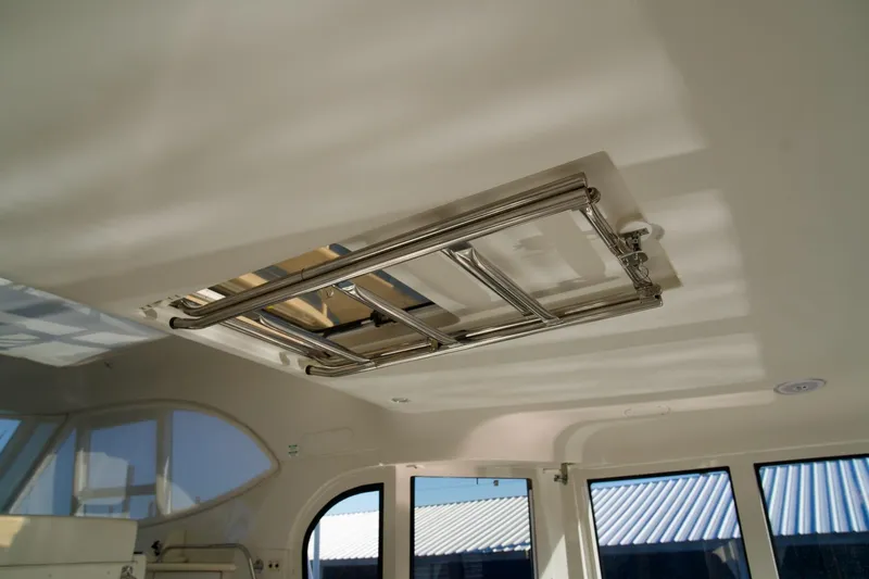  Yacht Photos Pics Ceiling view inside 2000 Carver 506 Motor Yacht, featuring a metal hatch.