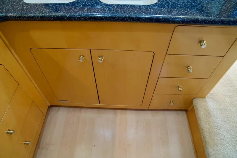  Yacht Photos Pics Wooden cabinetry with gold knobs in a 2000 Carver 506 Motor Yacht kitchen.