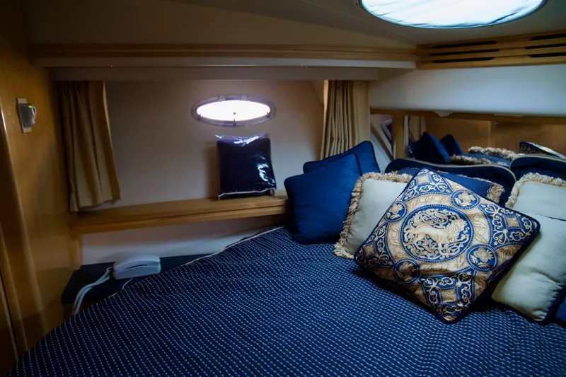  Yacht Photos Pics Luxurious bedroom interior of 2000 Carver 506 Motor Yacht with elegant pillows and bedding.