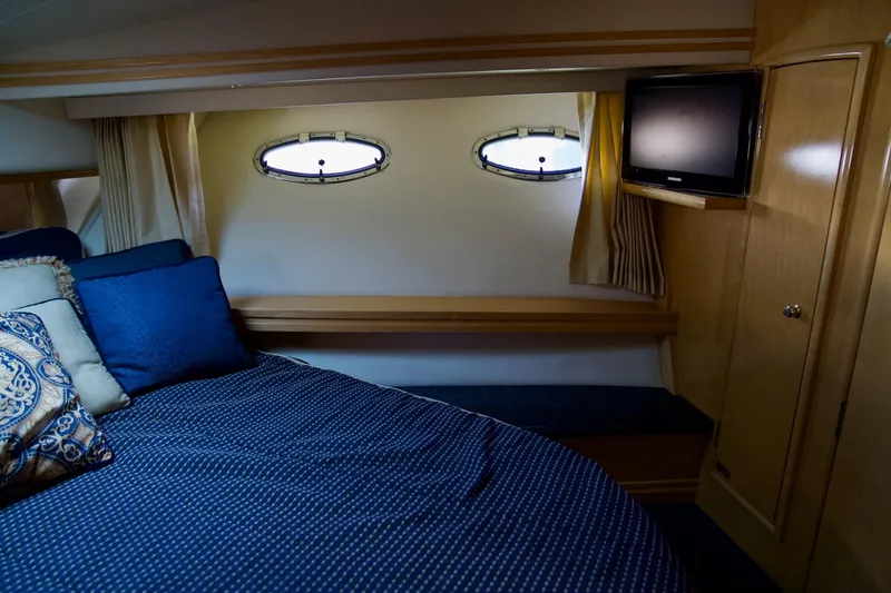  Yacht Photos Pics Cozy bedroom in 2000 Carver 506 Motor Yacht with portholes and TV.