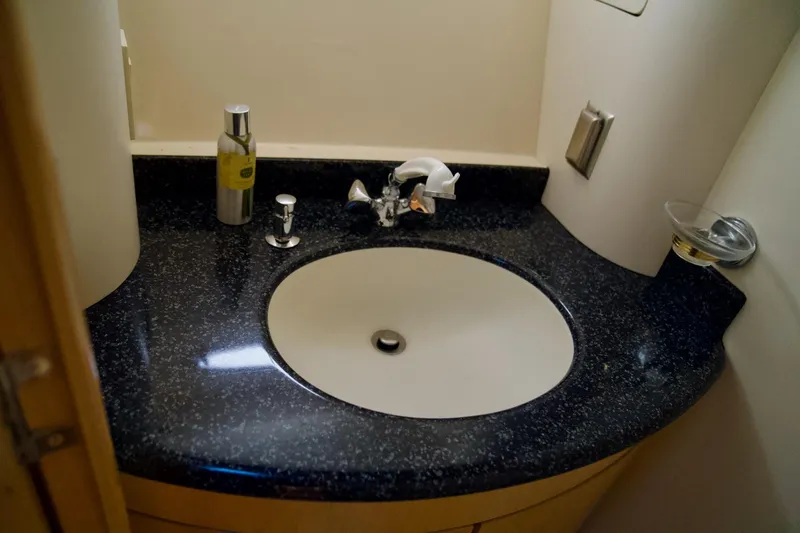  Yacht Photos Pics Bathroom sink in 2000 Carver 506 Motor Yacht with black countertop and chrome fixtures.