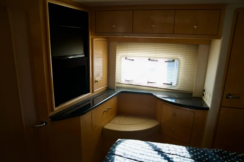  Yacht Photos Pics Luxurious interior of 2000 Carver 506 Motor Yacht with elegant wood cabinetry and window blinds.