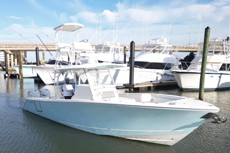  Yacht Photos Pics 2020 Cobia 350 Center Console boat docked in marina with other yachts.