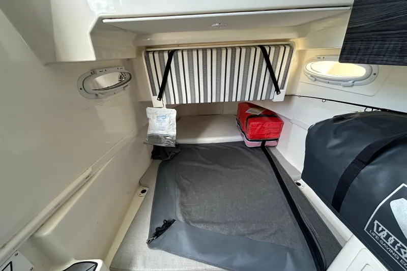  Yacht Photos Pics 2020 Cobia 350 Center Console cabin interior with storage bags and portholes.