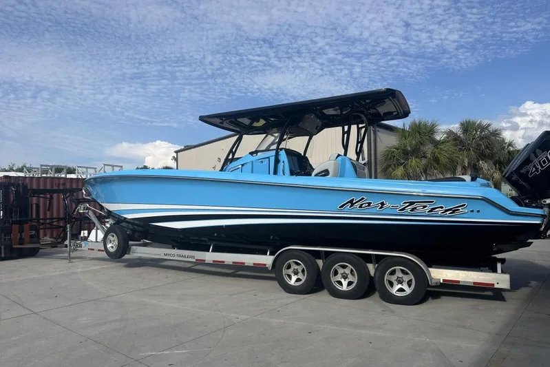  Yacht Photos Pics 2025 Nor-Tech 340 Sport Center Console boat on trailer, blue exterior, parked outdoors.