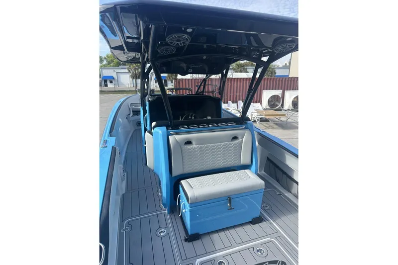  Yacht Photos Pics 2025 Nor-Tech 340 Sport Center Console boat with blue and gray seating, docked outdoors.