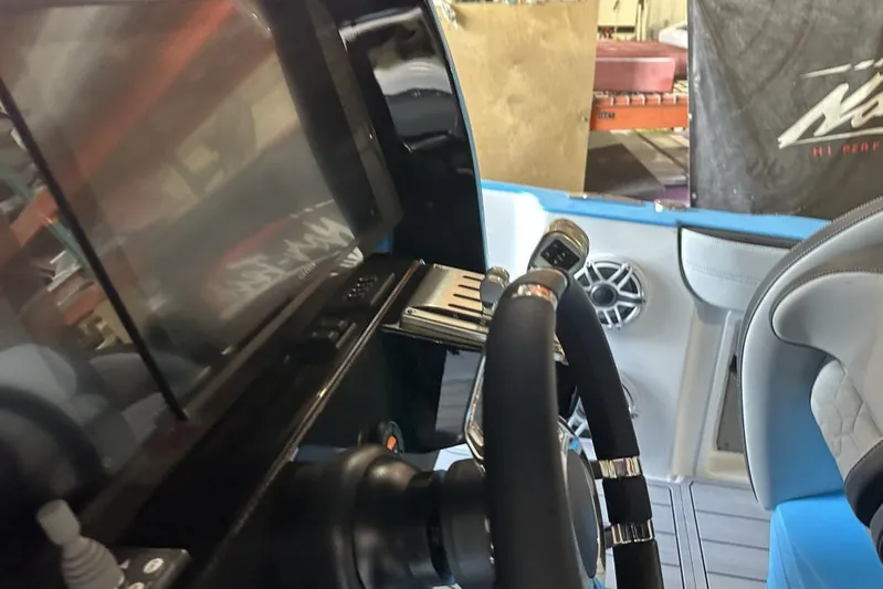  Yacht Photos Pics 2025 Nor-Tech 340 Sport Center Console interior with steering wheel and control panel.