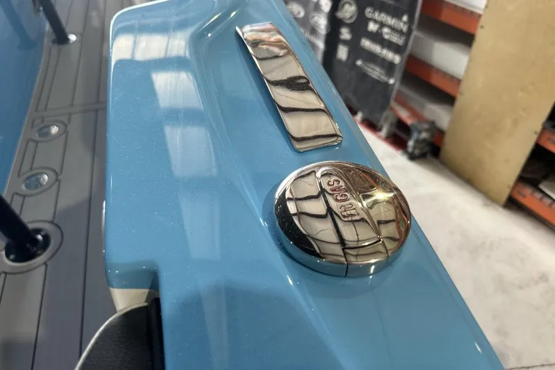  Yacht Photos Pics 2025 Nor-Tech 340 Sport Center Console, blue exterior with chrome gas cap detail.