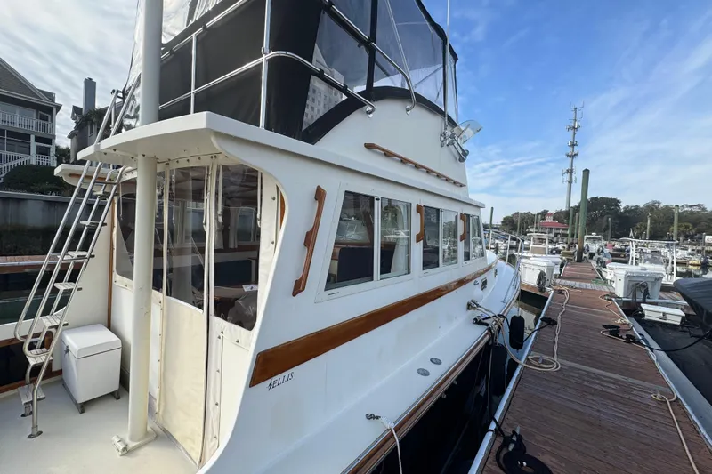 Gullywhumper Yacht Photos Pics 2001 Ellis 36 Flybridge yacht docked at marina, showcasing elegant design and spacious deck.