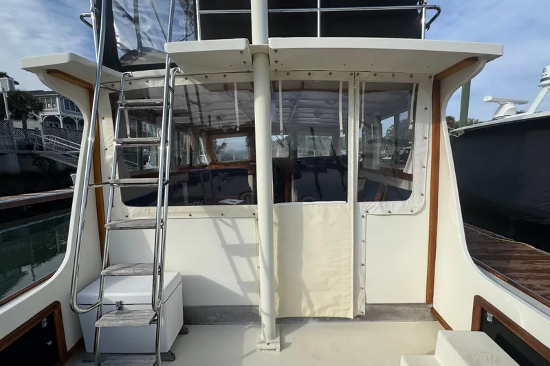 Gullywhumper Yacht Photos Pics 2001 Ellis 36 Flybridge boat with ladder and enclosed deck area.