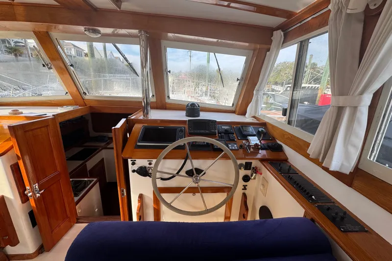 Gullywhumper Yacht Photos Pics Interior helm of 2001 Ellis 36 Flybridge boat with wooden accents and navigation equipment.