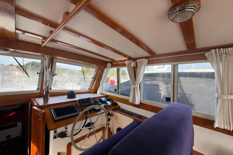 Gullywhumper Yacht Photos Pics Interior of 2001 Ellis 36 Flybridge boat with wooden helm and navigation equipment.