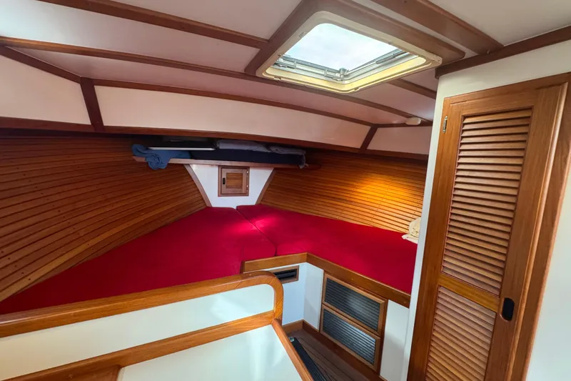 Gullywhumper Yacht Photos Pics Cozy cabin interior of 2001 Ellis 36 Flybridge with red bedding and wooden accents.