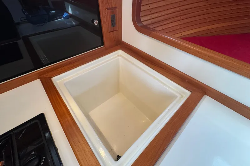 Gullywhumper Yacht Photos Pics Interior of 2001 Ellis 36 Flybridge boat featuring a built-in sink with wooden trim.