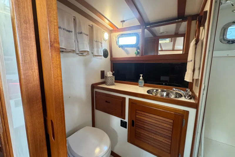 Gullywhumper Yacht Photos Pics Luxurious bathroom interior of 2001 Ellis 36 Flybridge yacht with wooden accents and modern amenities.