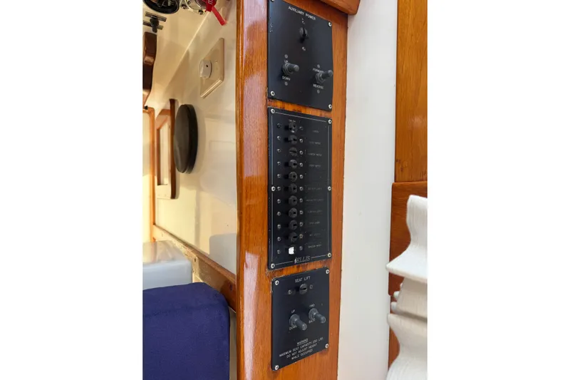 Gullywhumper Yacht Photos Pics Control panel on a 2001 Ellis 36 Flybridge boat, featuring switches and wooden trim.