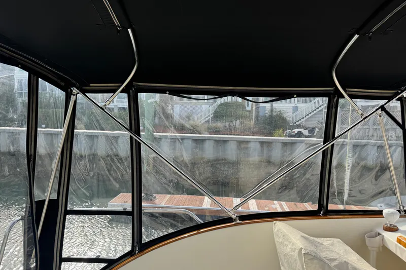 Gullywhumper Yacht Photos Pics Interior view of 2001 Ellis 36 Flybridge boat with clear windows and dockside scenery.